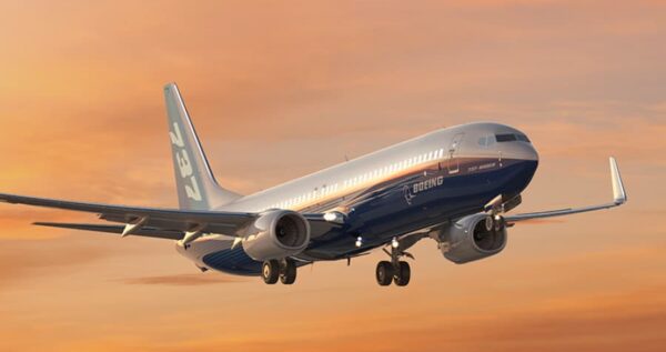 Boeing 737 in flight at sunset