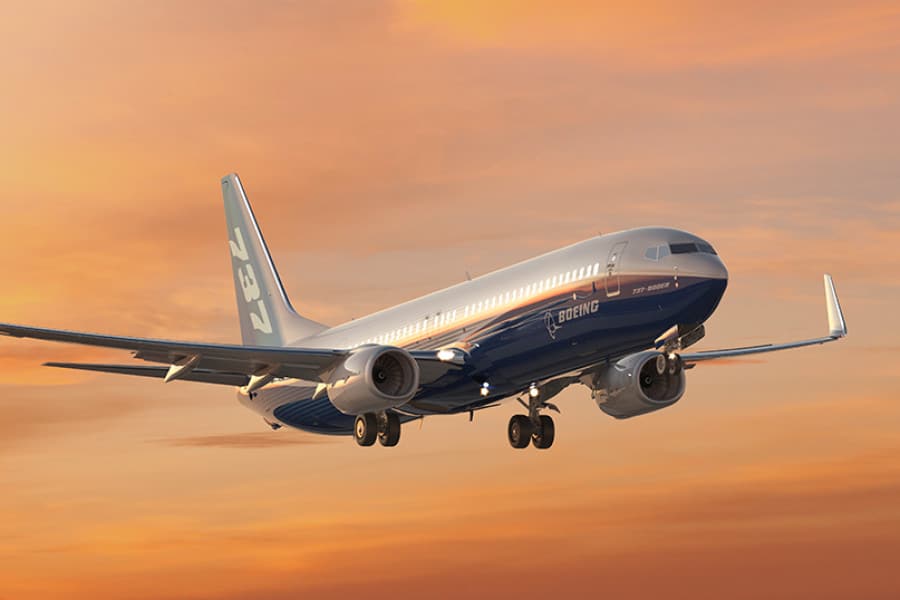 Boeing 737 in flight at sunset