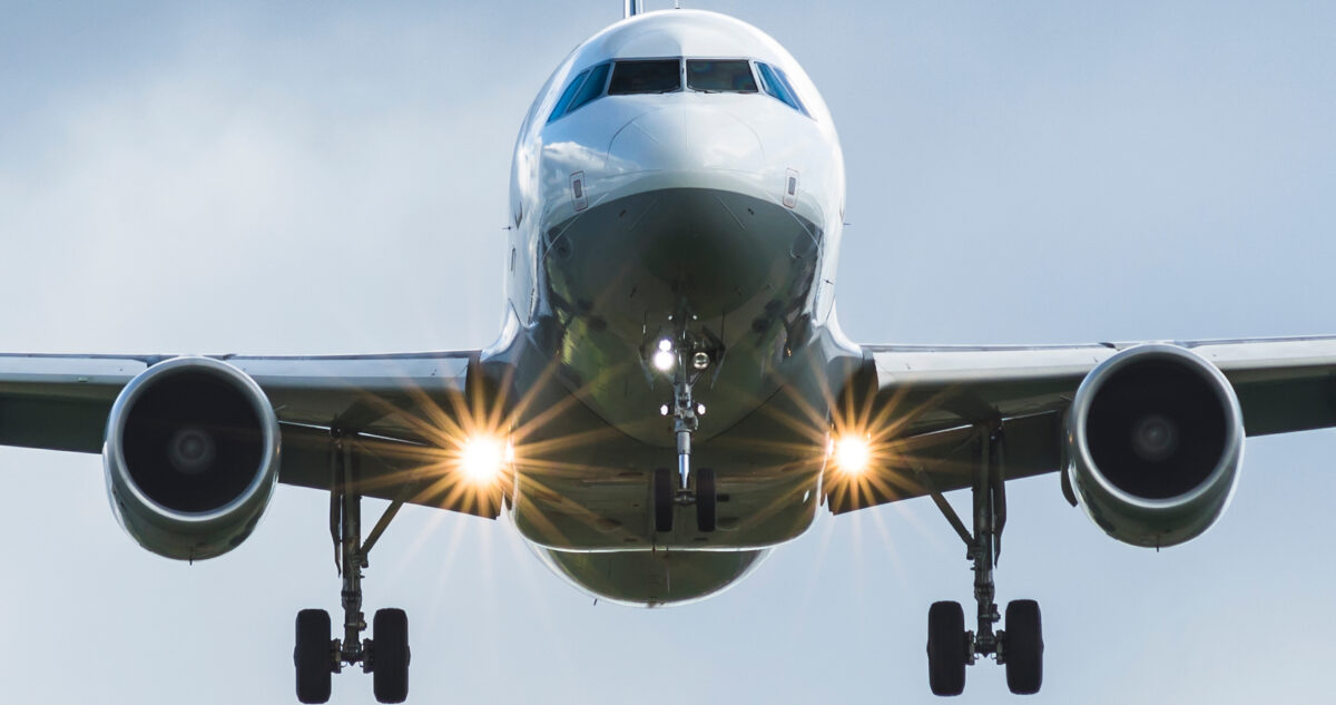 Close Up On A White Plane With Landing Lights About To Land